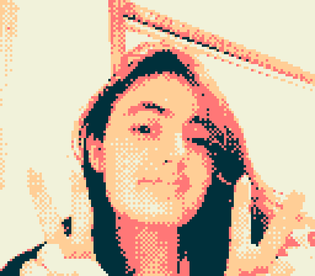 Image of a person smiling and holding up two peace signs. The image is pixelated and has an orange-red filter placed over it.